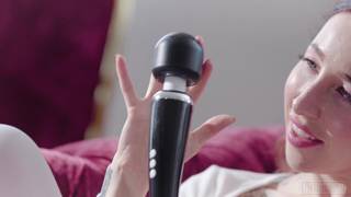 Eine tätowierte Frau spielt solo mit ihrem Vibrator